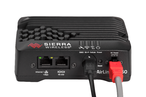 A black box with red and white cables Description automatically generated